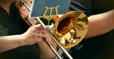 Playing trumpet.